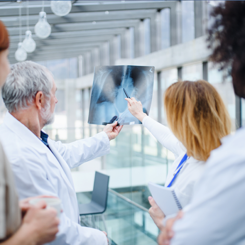 A group of clinicians review an x-ray image.