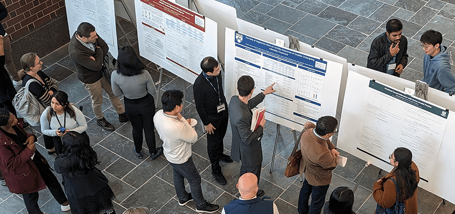 Research Day attendees look at a poster exhibition at the 2024 Research Day.